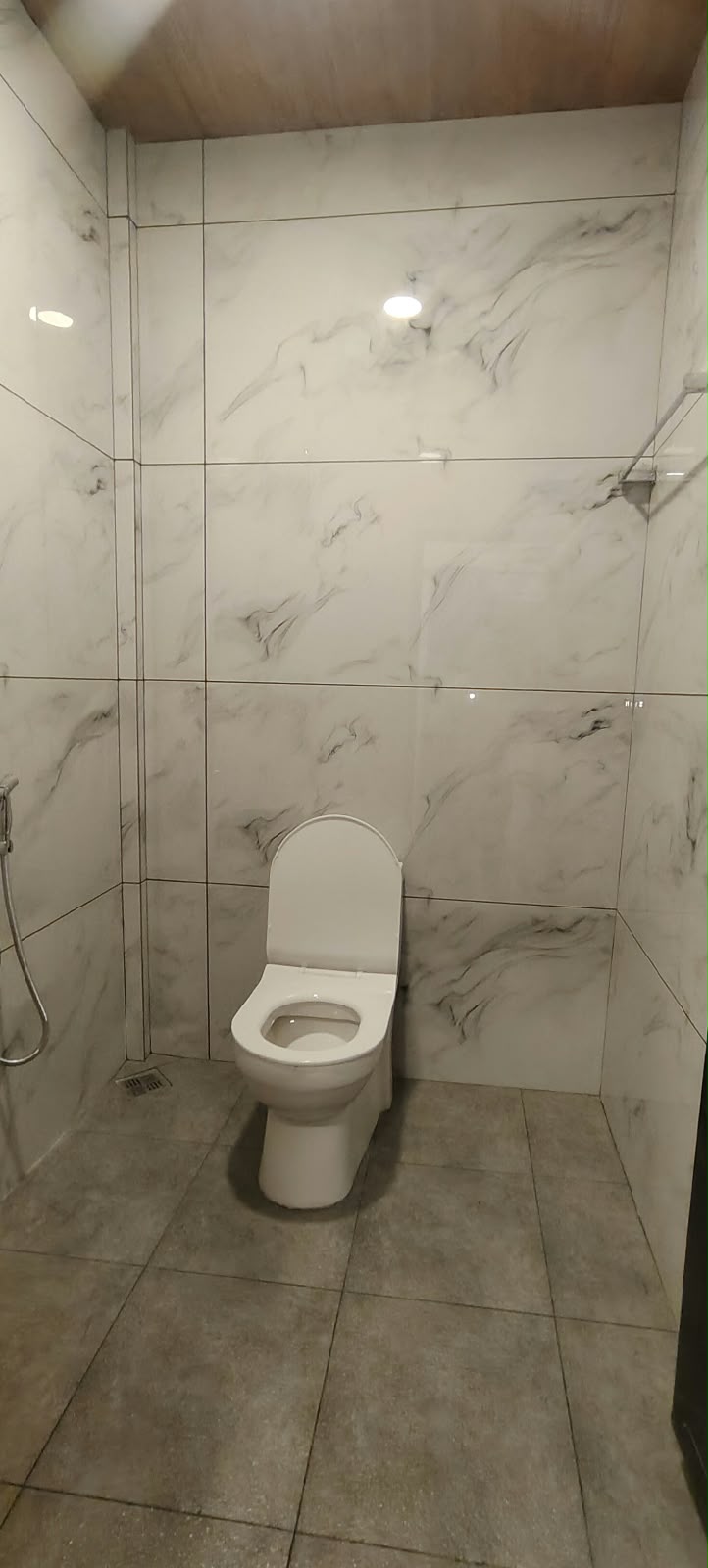 Modern tiled bathroom with 24-hour hot water geyser and clean amenities